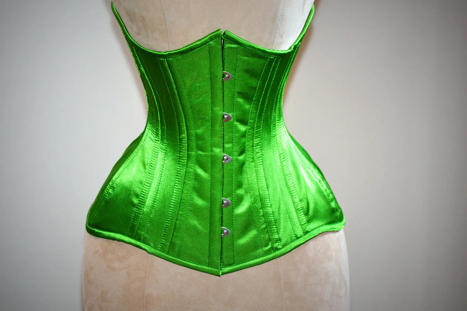 Real double row steel boned underbust corset from satin in a fashionable green grass summer color.